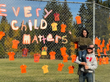 students in front of Orange Shirt display