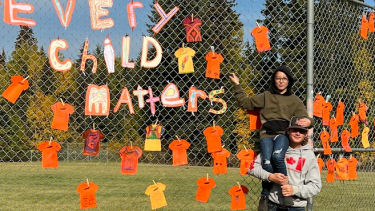 students in front of Orange Shirt display